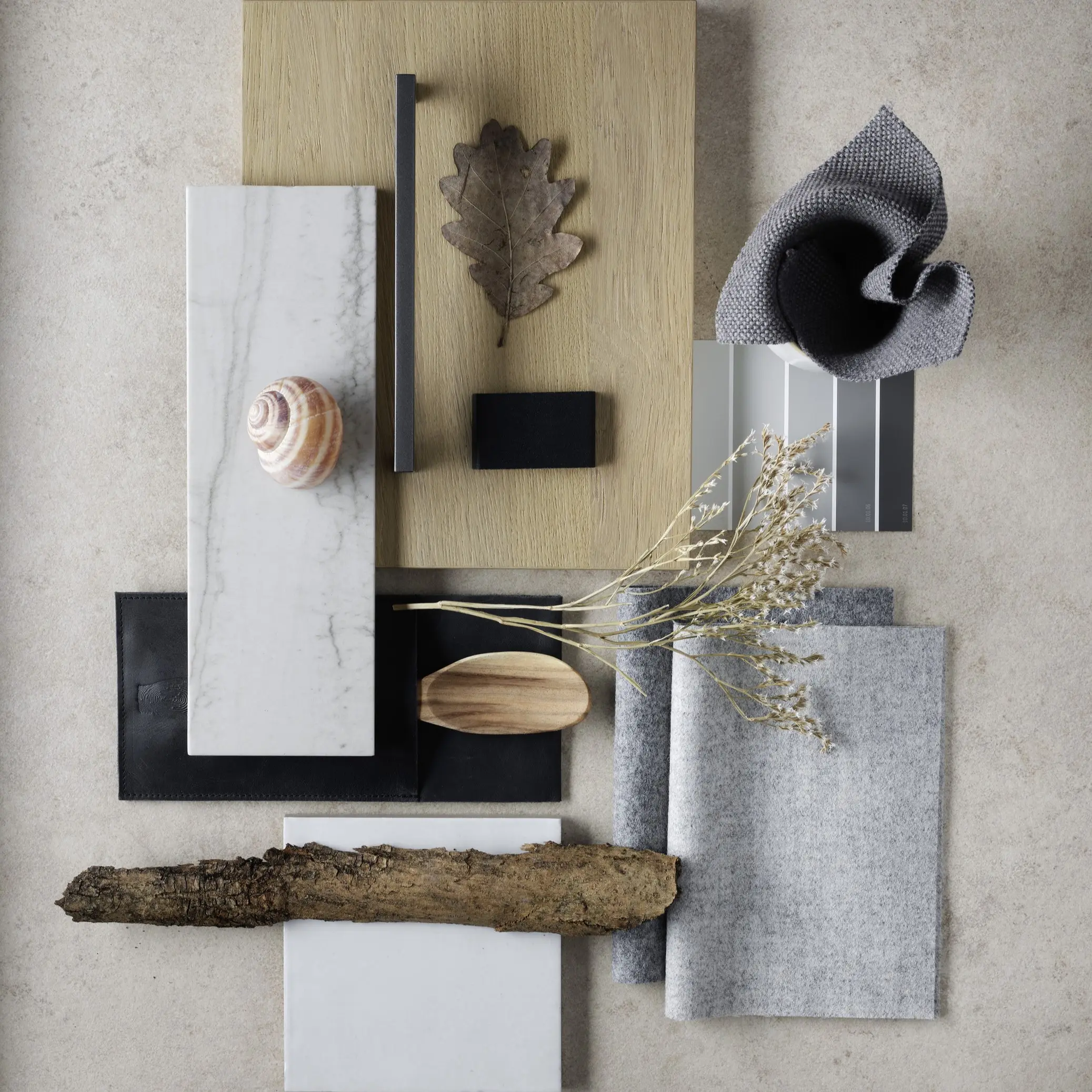 Musterbrett mit Material- und Farbproben aus Stein, Holz, Filz und Leder